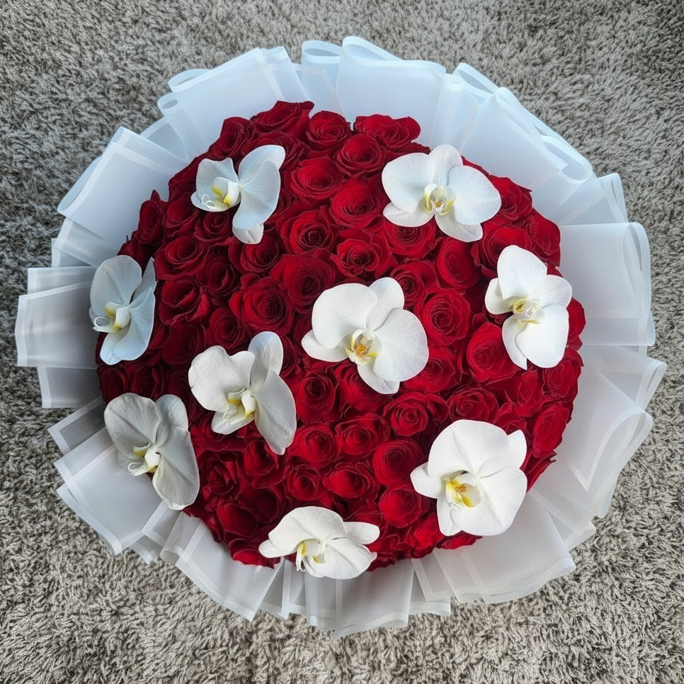 Bouquet arrangement of red roses and white orchids