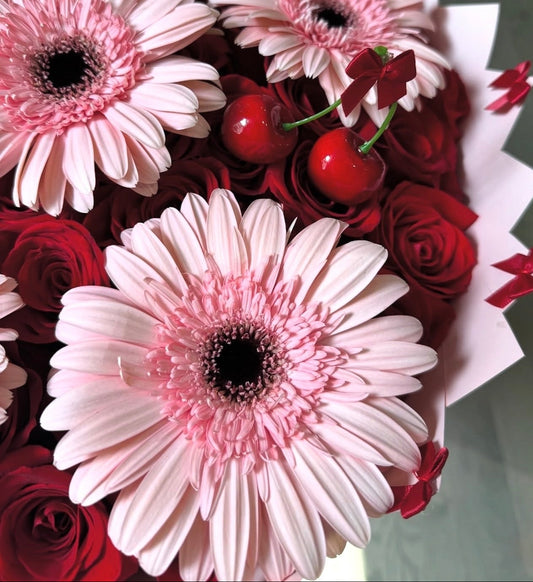 Bouquet of pink and red flowers with cherries