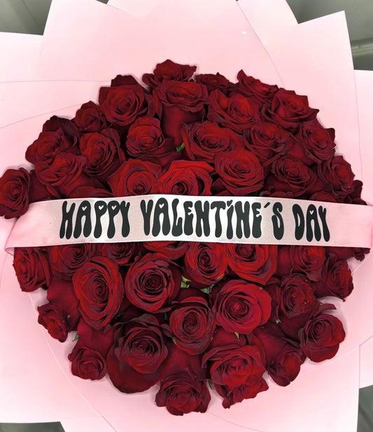 Bouquet of red roses with pink wraps