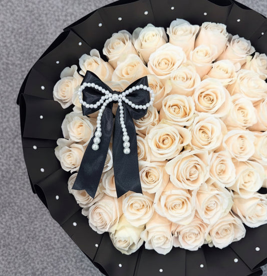 Bouquet of white roses with a black bow