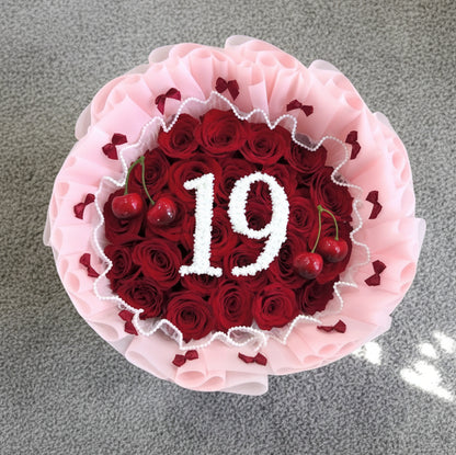 vancouver pink wrapped Bouquet of red roses with inituals and cherries on top 
