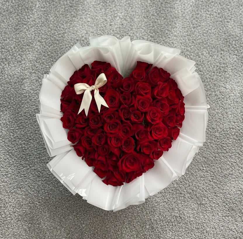 Vancouver Heart-shaped arrangement of red roses with a white ribbon 