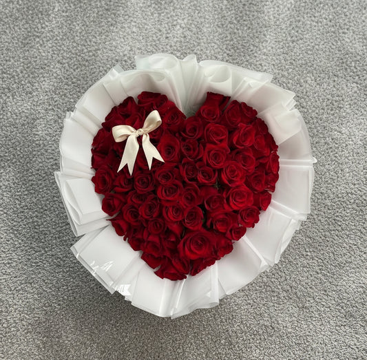 Vancouver Heart-shaped arrangement of red roses with a white ribbon 