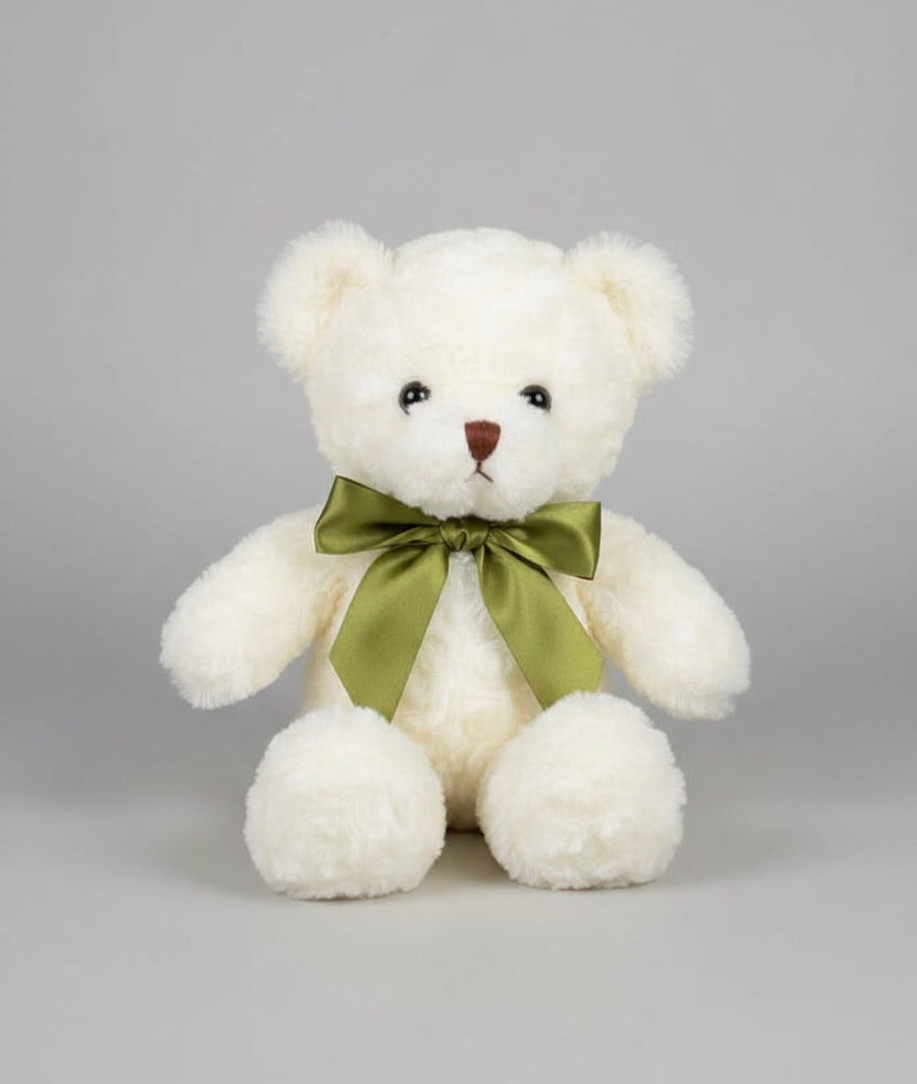 White teddy bear with a green bow
