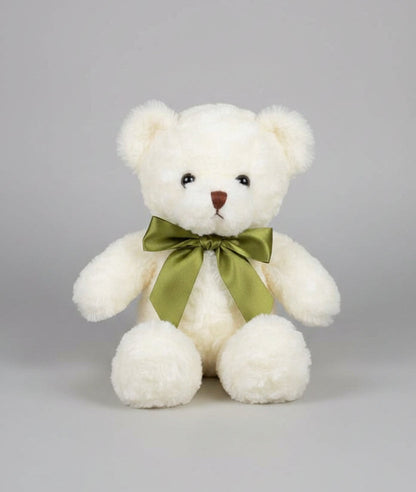 White teddy bear with a green bow