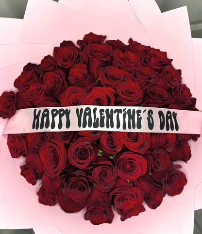 Bouquet of red roses with pink wraps