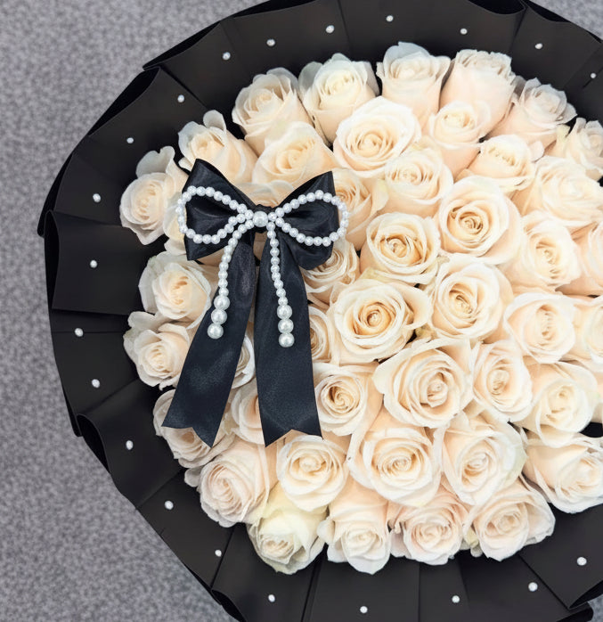 Bouquet of white roses with a black bow