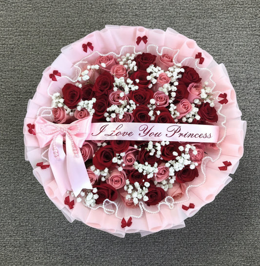 Bouquet of red and pink roses with a pink wrapped