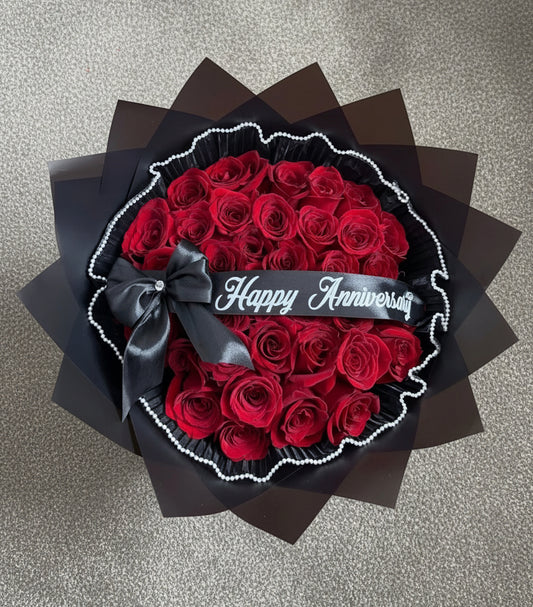 Bouquet of red roses with a black bow 