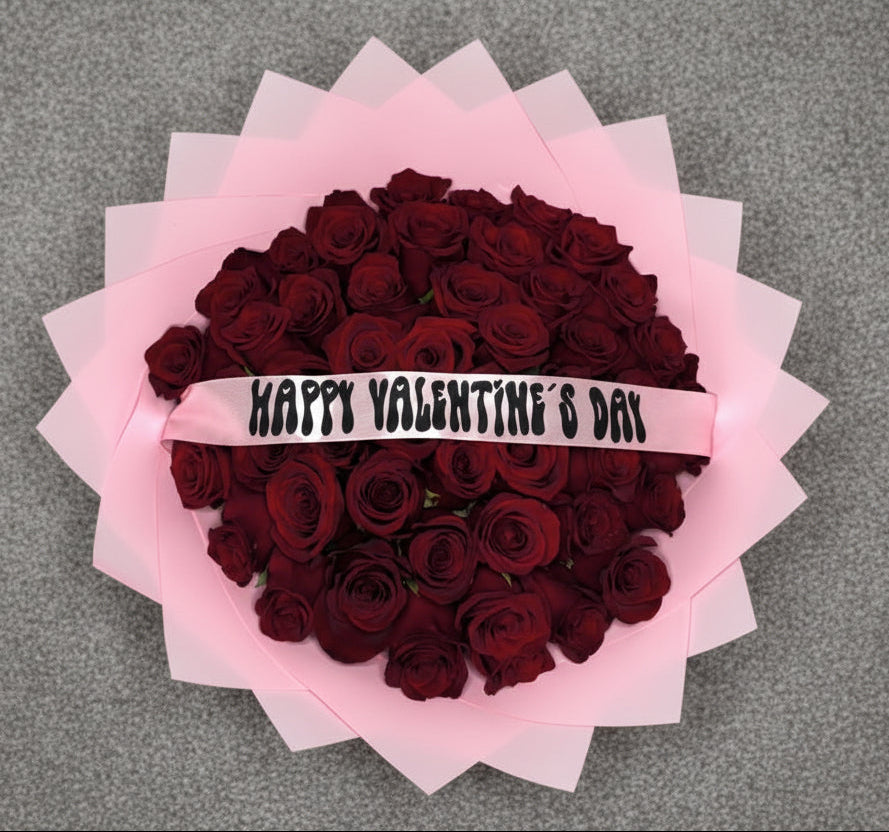 Bouquet of red roses with pink wraps