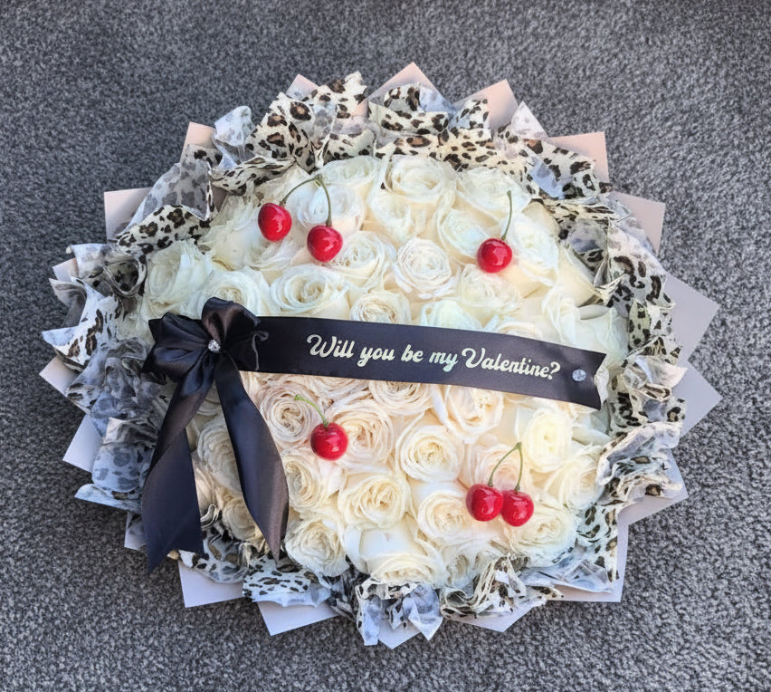Bouquet of white roses with cherries and a black ribbon on a car seat.