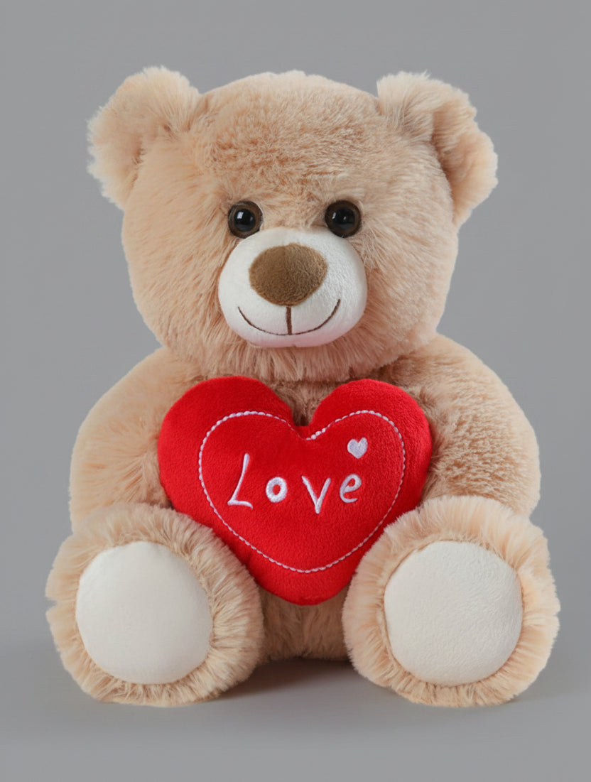 Plush teddy bear holding a red heart with 'Love' written on it against a white background